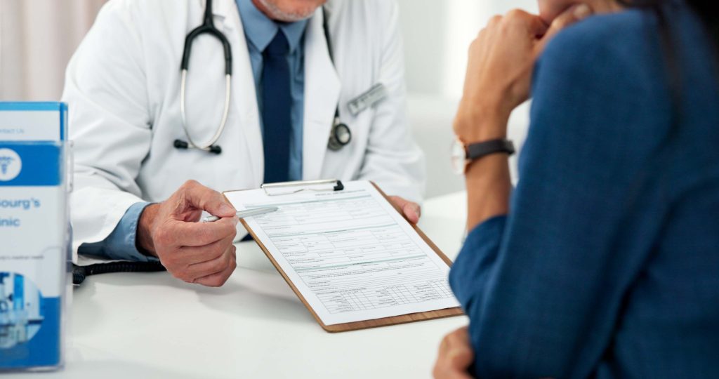 A doctor prescribing medicines to a patient.