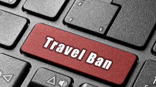 Keyboard with Enter key replaced by a 'Travel Ban' key, symbolizing how one search can reveal a UAE travel ban