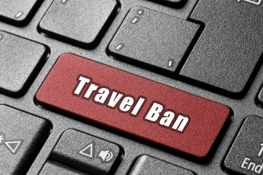Keyboard with Enter key replaced by a 'Travel Ban' key, symbolizing how one search can reveal a UAE travel ban